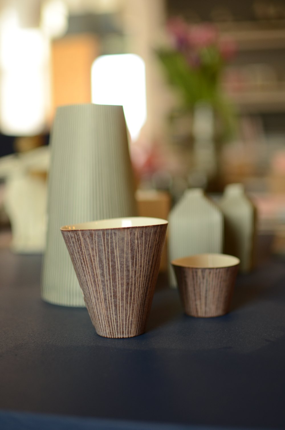 Tall, porceline vessels by Justine Allison