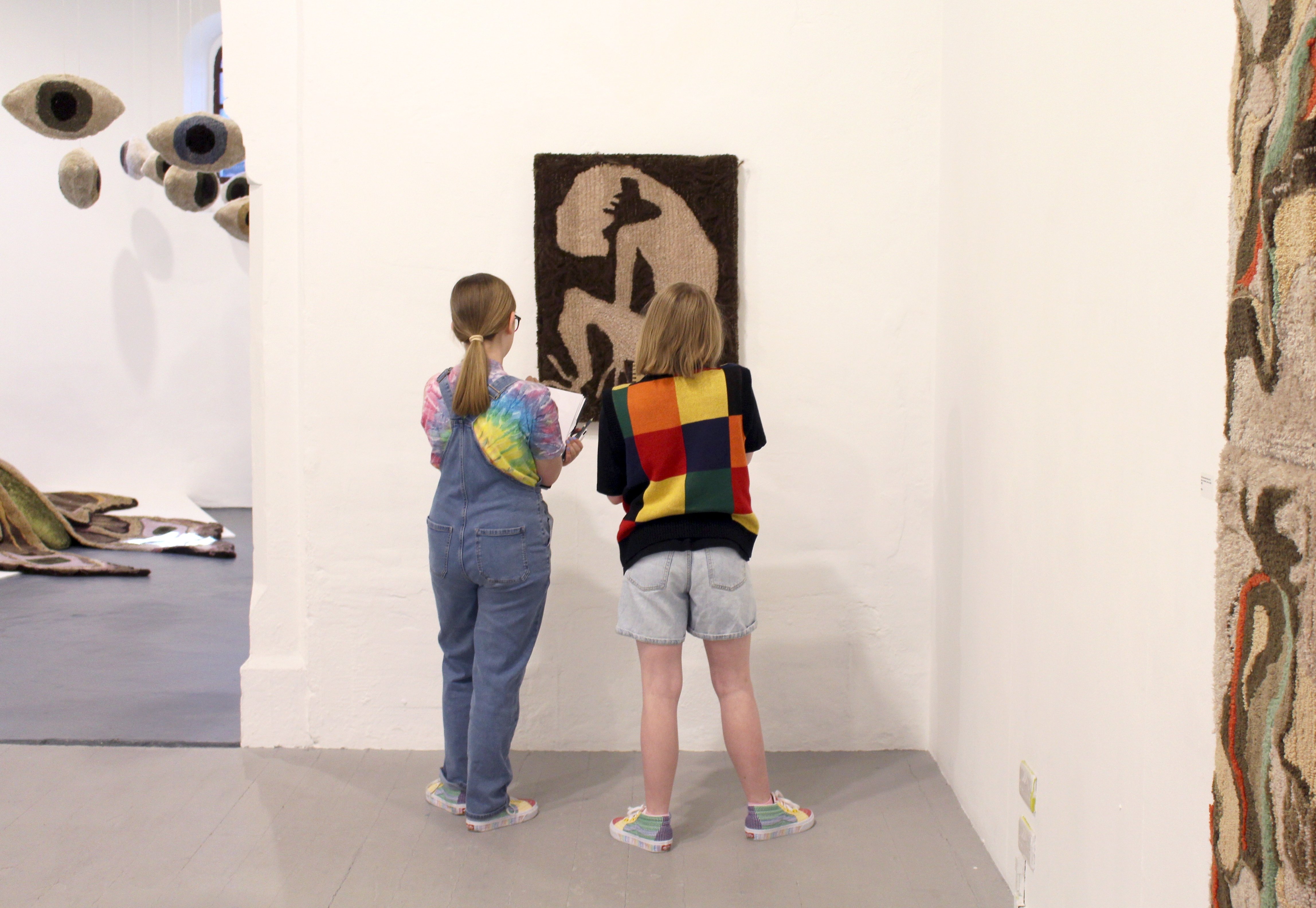 Two workshop participants looking at Non's artwork 'Exhale' in gallery space
