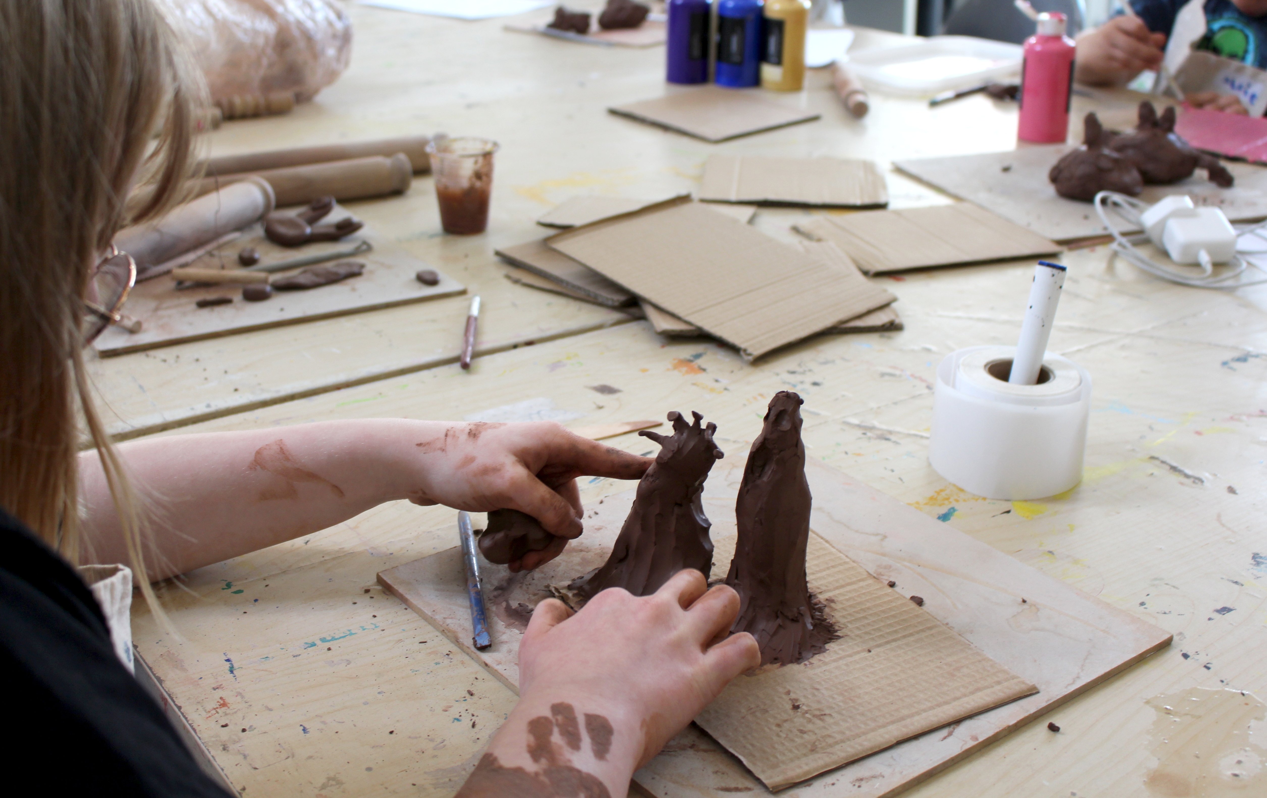 Workshop participants moulding clay into form
