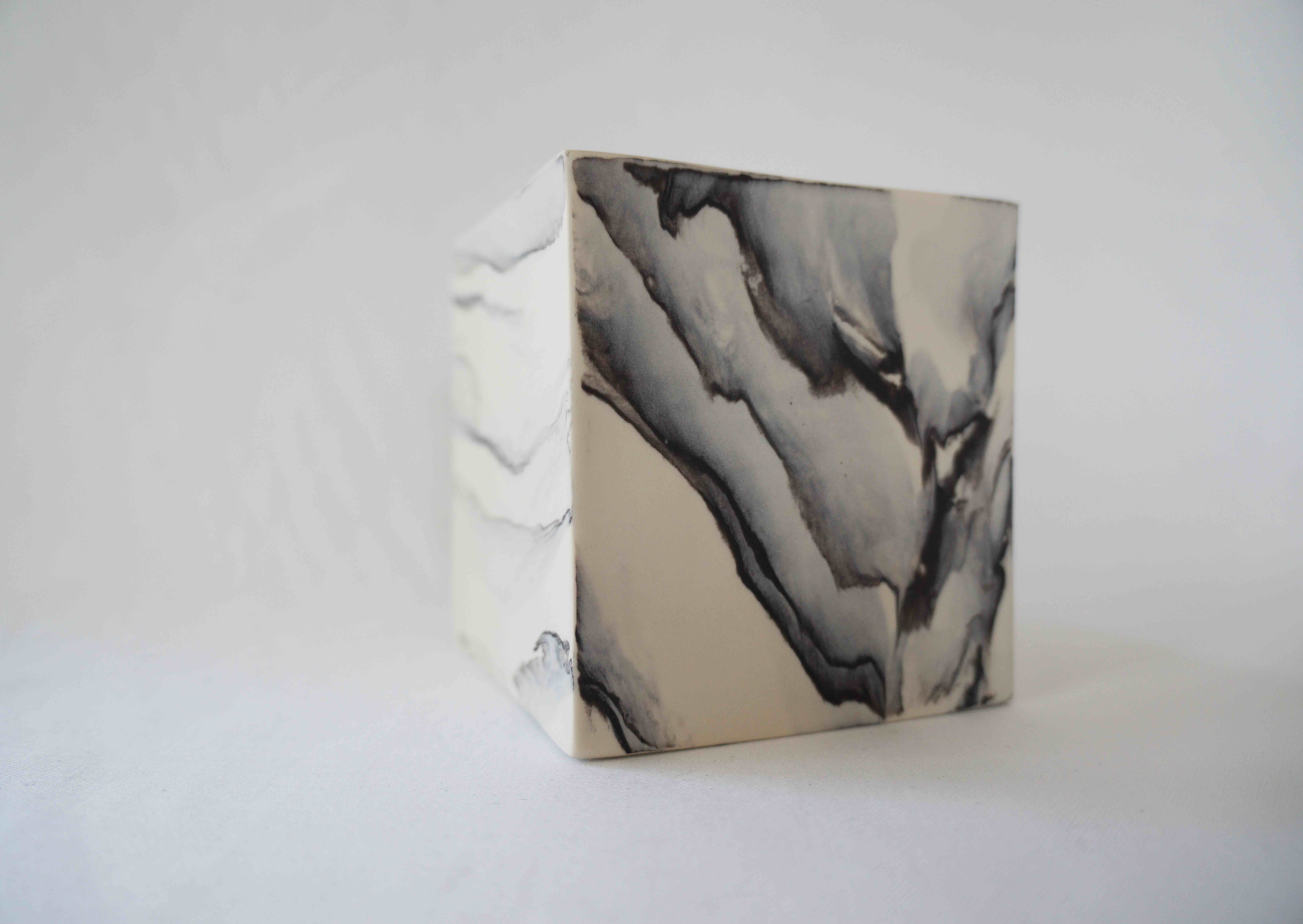 A monochrome pocelain cube form by ceramicist Kim Colebrook