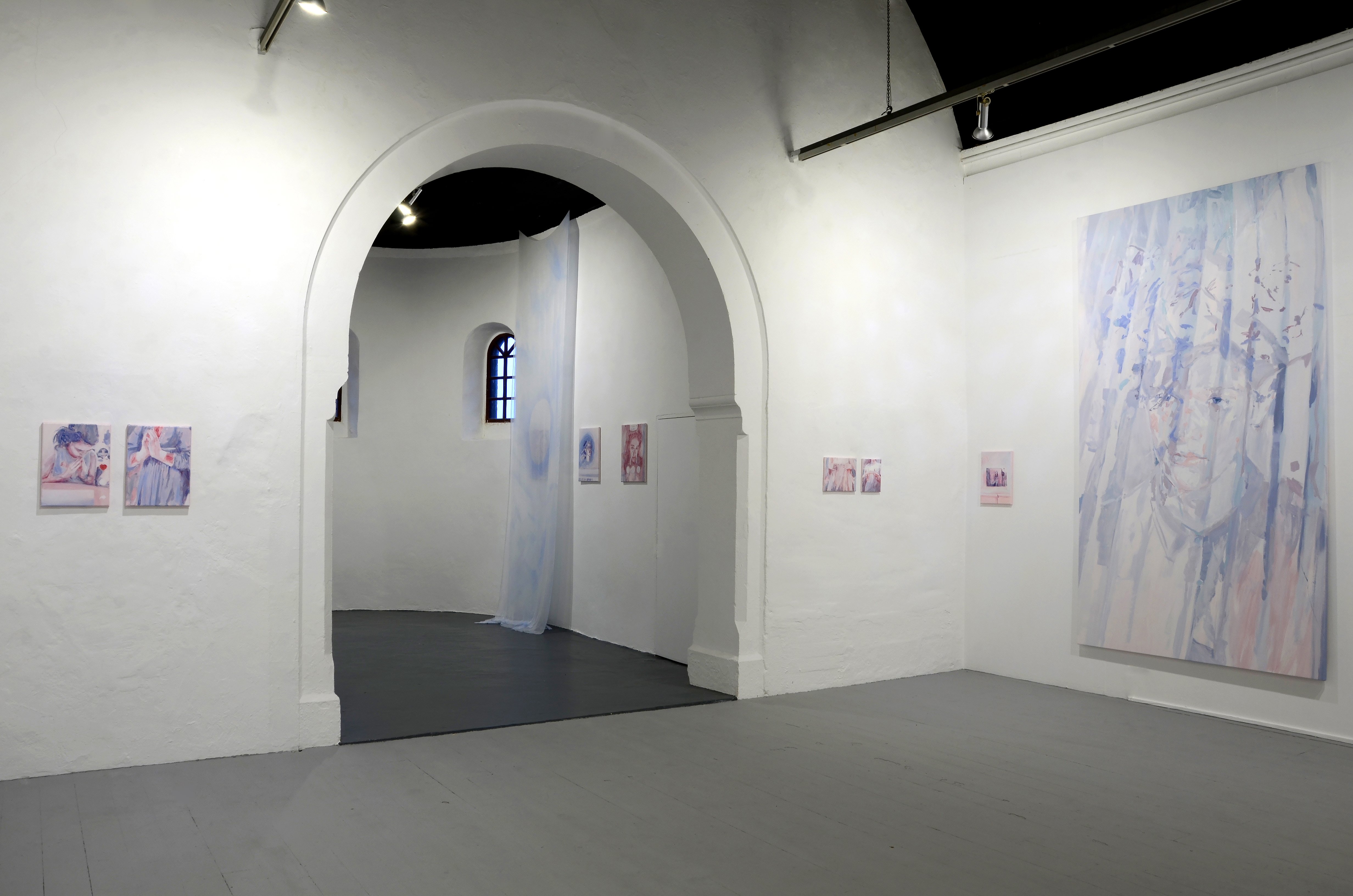 Come fail at love exhibition by Casper White. Image includes a large painting painted in muted pink and blue colours. The image includes a portrait of a young man, from shoulders upwards. The canvas has soft painted vertical pleating across the figure.