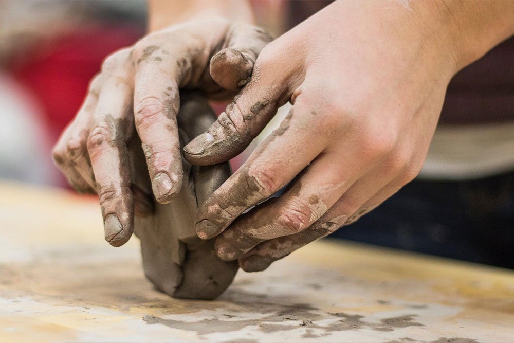 Child rolling clay