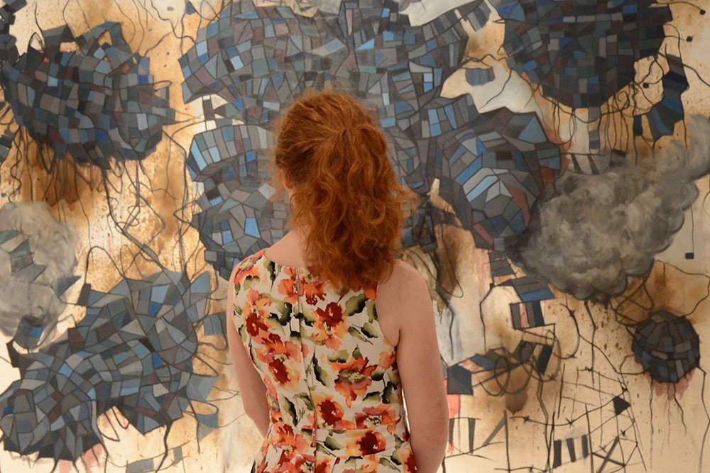 Gallery Talk - image of student looking at painting by Jon Powell