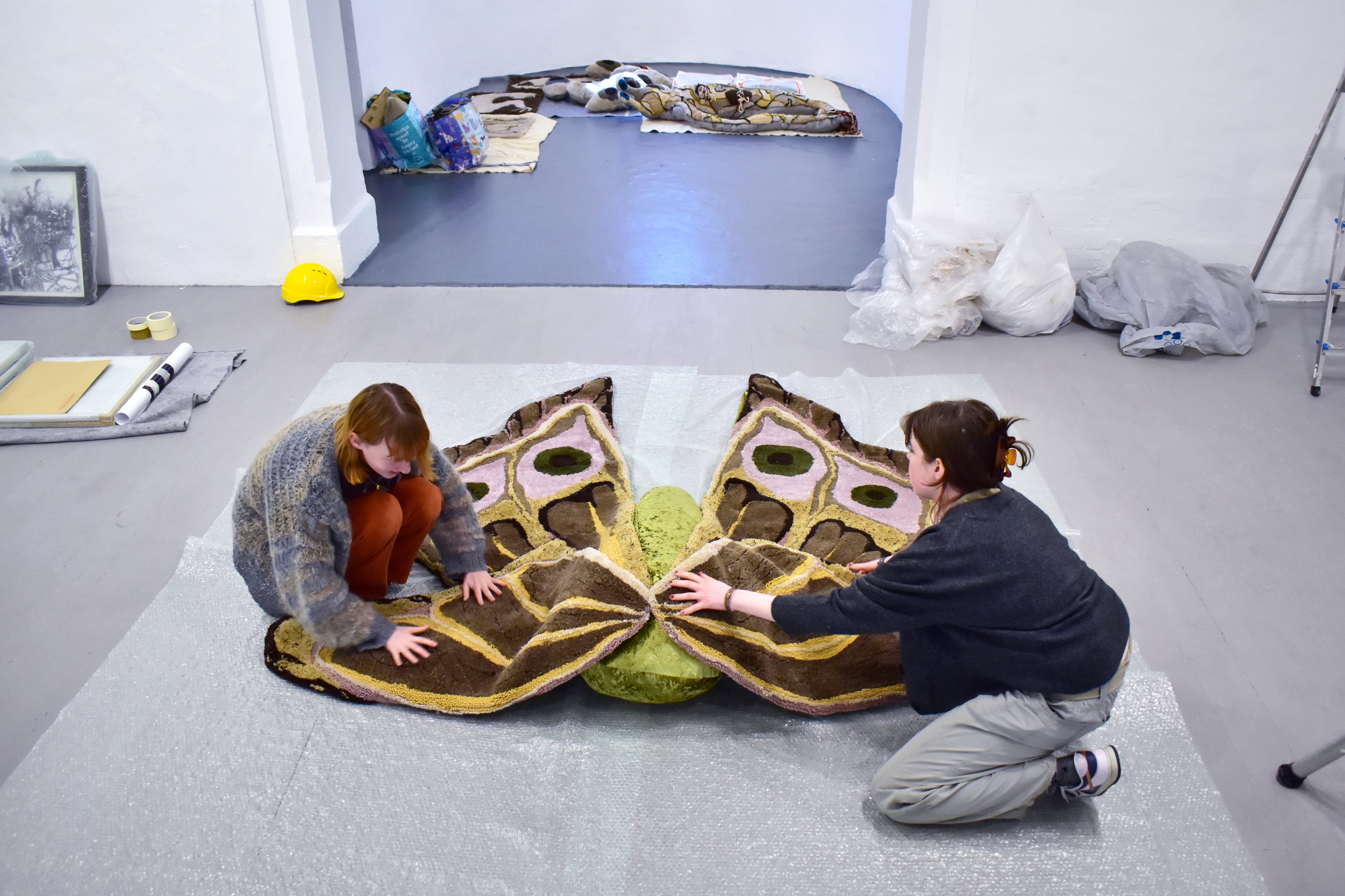 Non arranging her work together, her large-scale textile moth, in the exhibition space.